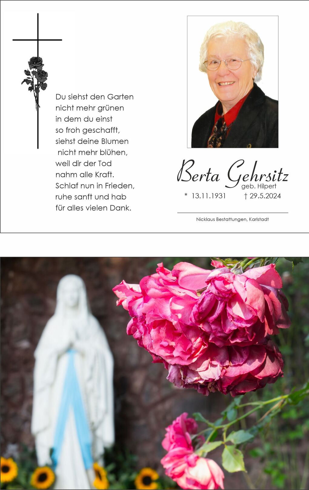 Nahaufnahme von pinken Rosenbl&uuml;ten vor einer Statue der Jungfrau Maria im Hintergrund.