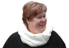 L&auml;chelnde Frau mit kurzen, braunen Haaren und einem wei&szlig;en Loop-Schal vor wei&szlig;em Hintergrund.