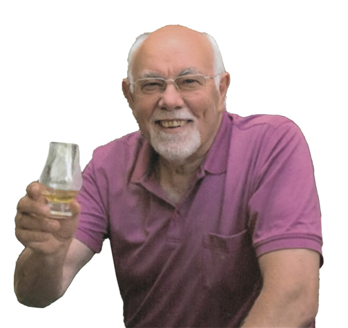 &Auml;lterer Mann in lila Poloshirt h&auml;lt ein Glas mit Getr&auml;nk und l&auml;chelt in die Kamera.