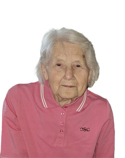 &Auml;ltere Frau mit hellblonden Haaren tr&auml;gt ein rosa Polohemd und schaut freundlich in die Kamera.