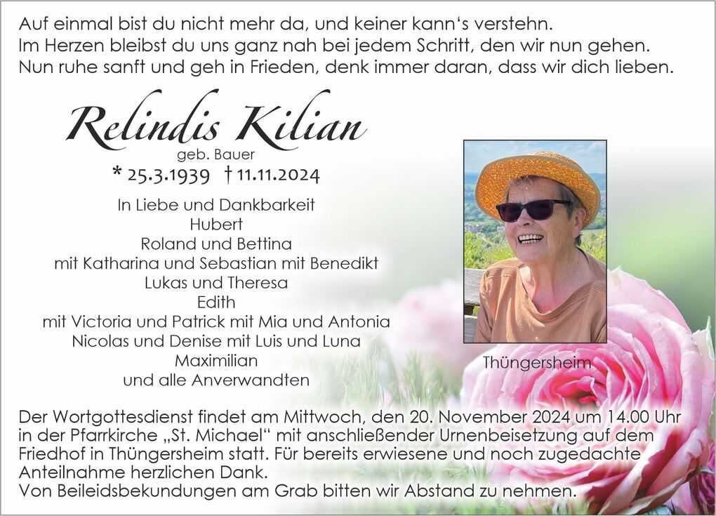 Traueranzeige f&uuml;r Relindis Kilian, mit Bild einer l&auml;chelnden Frau in Sonnenhut vor Blumenhintergrund.
