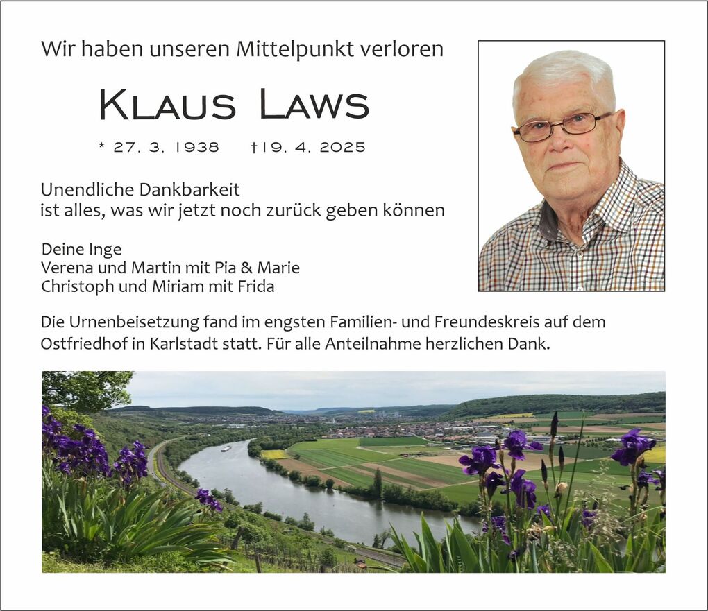 Traueranzeige f&uuml;r Klaus Laws mit einem Landschaftsbild und lila Bl&uuml;ten im Vordergrund, Fluss und Ort im Hintergrund.